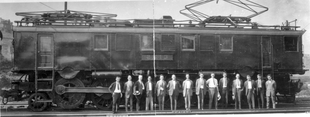 Miniature of Dean Ralph W. Goddard and group of men standing in front of train