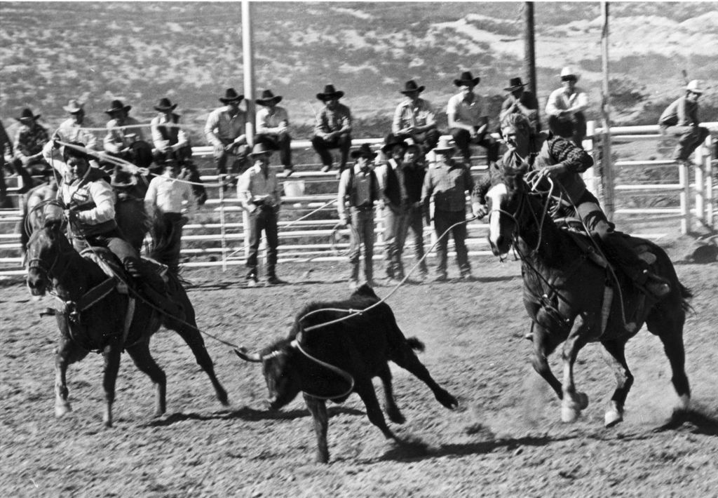 Miniature of Fred Huff and man competing in calf-roping rodeo event